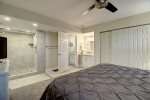 Master suite with king size bed, walk in shower, private vanity, and closet space